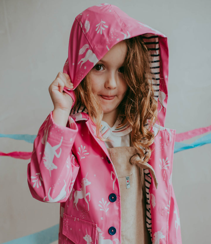 model wearing Sustainable recycled unicorn print Raincoat with hood