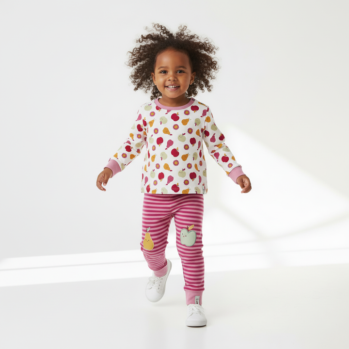 Child wearing a colorful outfit with a white background