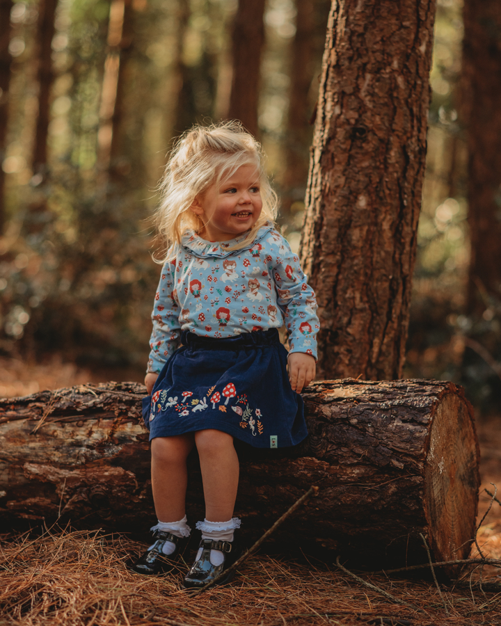 model wearing sustainable kids Embroidered Border Woodland Skirt