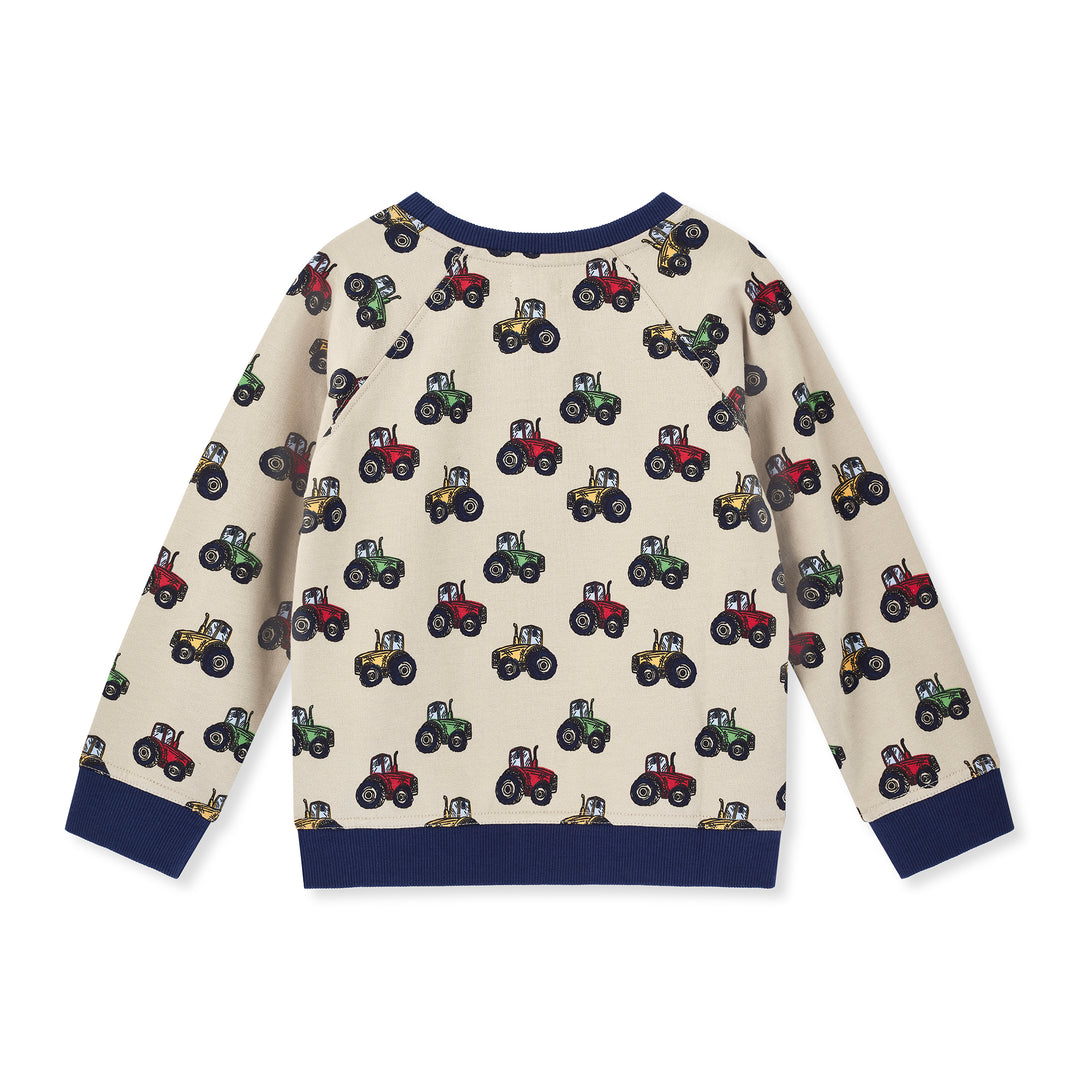 Children's sweater with tractor pattern on a white background
