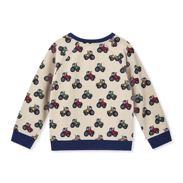 Children's sweater with tractor pattern on a white background