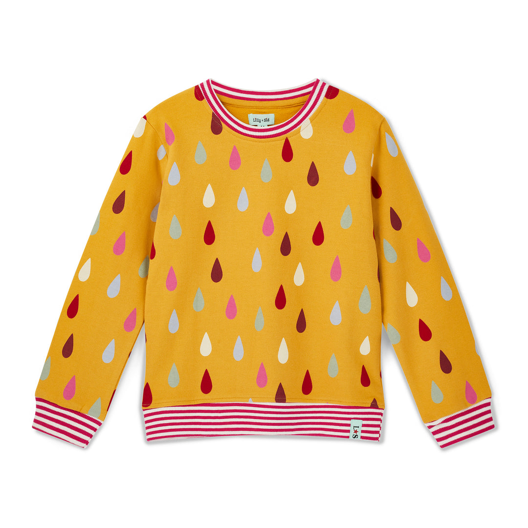 Yellow sweater with colorful drop pattern on a white background