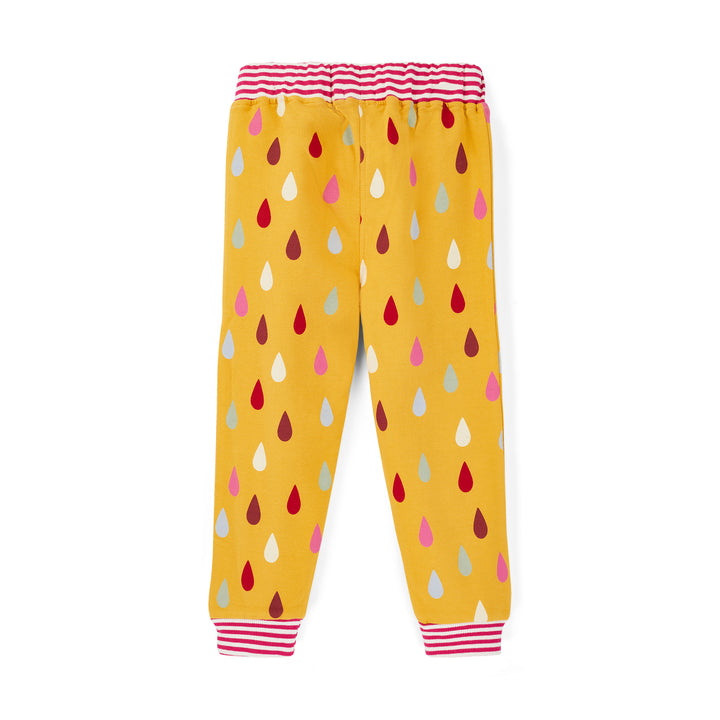 Yellow children's pants with colorful drop pattern on a white background