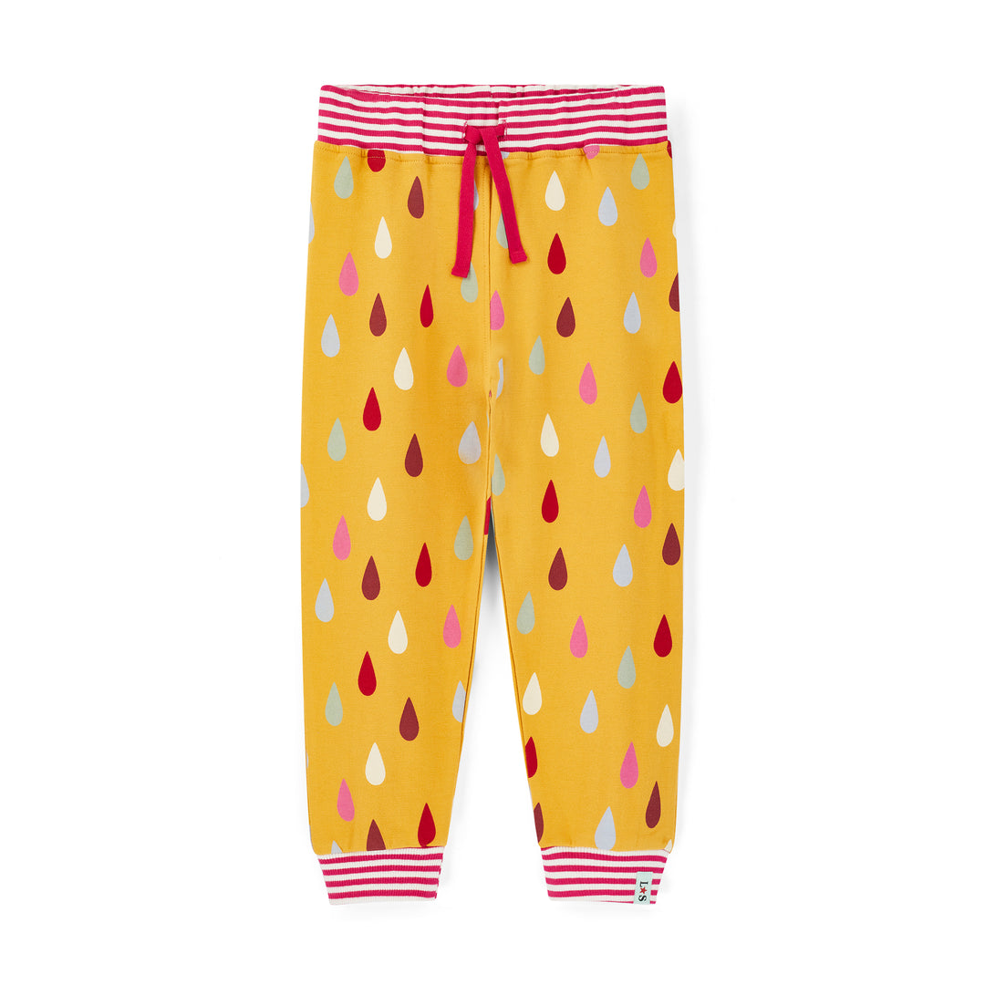 Yellow children's pants with colorful drop pattern and red striped waistband on a white background