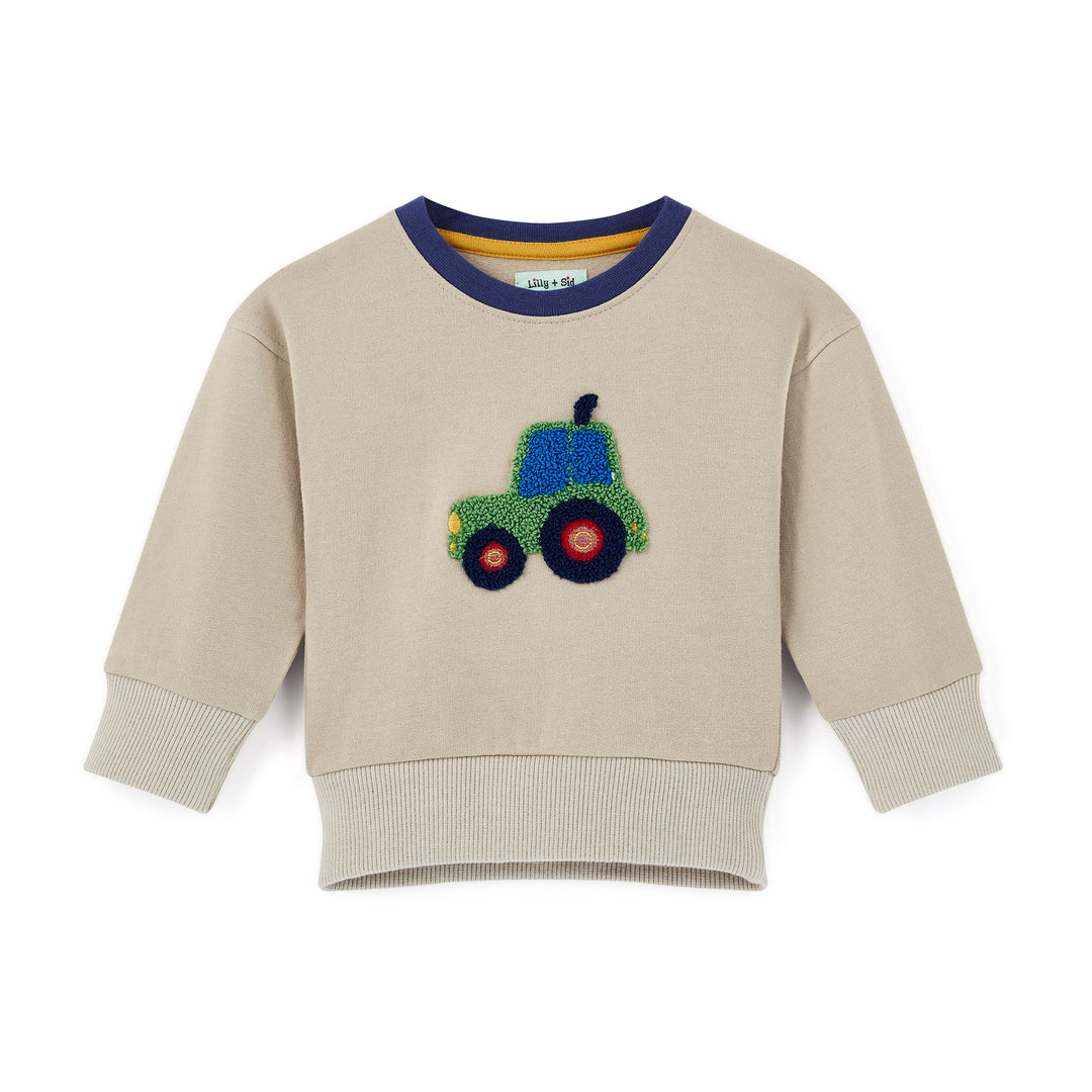 Beige sweatshirt with a colorful tractor design on a white background