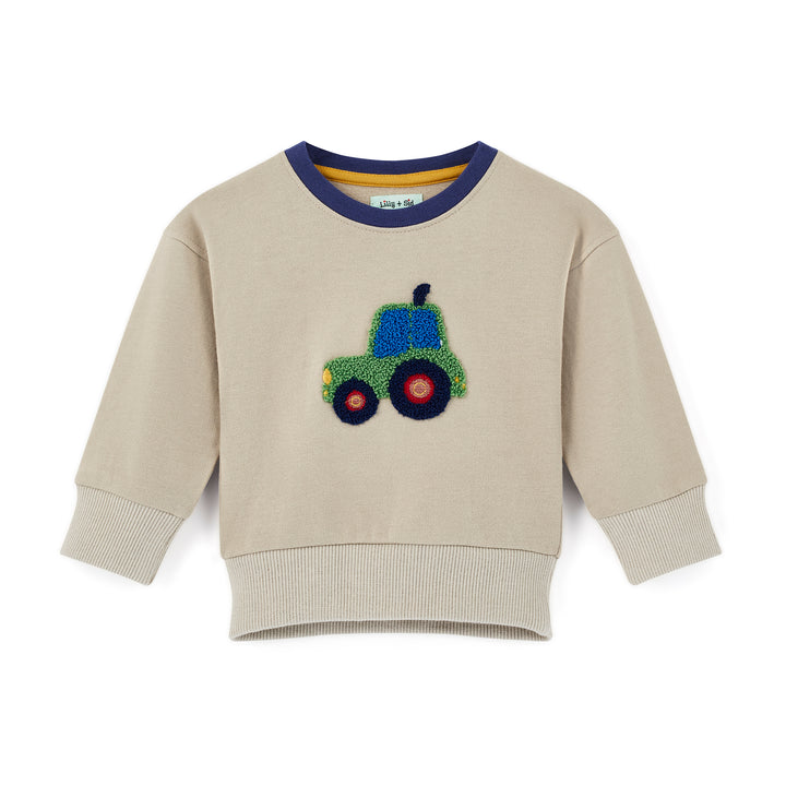 Beige sweatshirt with a colorful tractor design on a white background