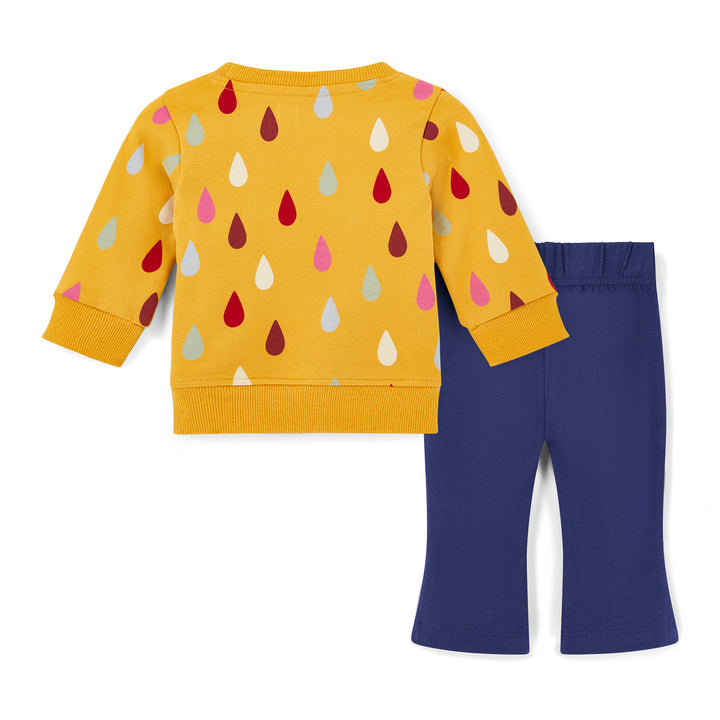 Yellow sweater with colorful raindrop pattern and blue pants on a white background