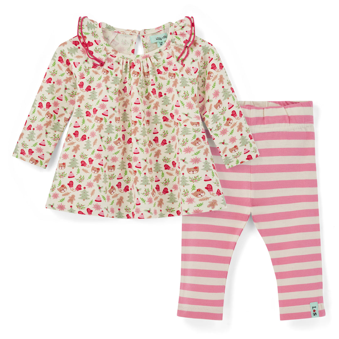 Children's outfit with floral top and pink striped pants on a white background