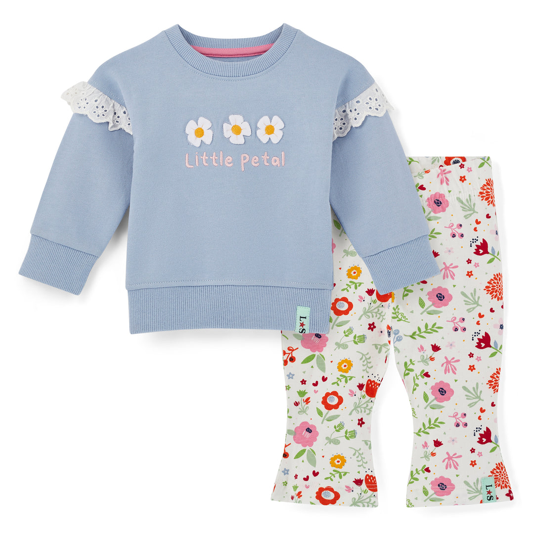 Children's outfit with blue sweatshirt and floral pants on a white background