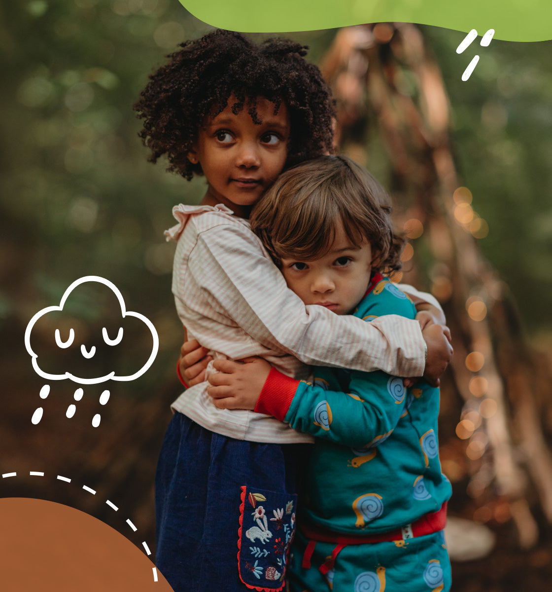 2 children hugging, one wearing Lilly and Sid organic snail print matching set and the other our navy cord skirt and stripe print long sleeve top. 