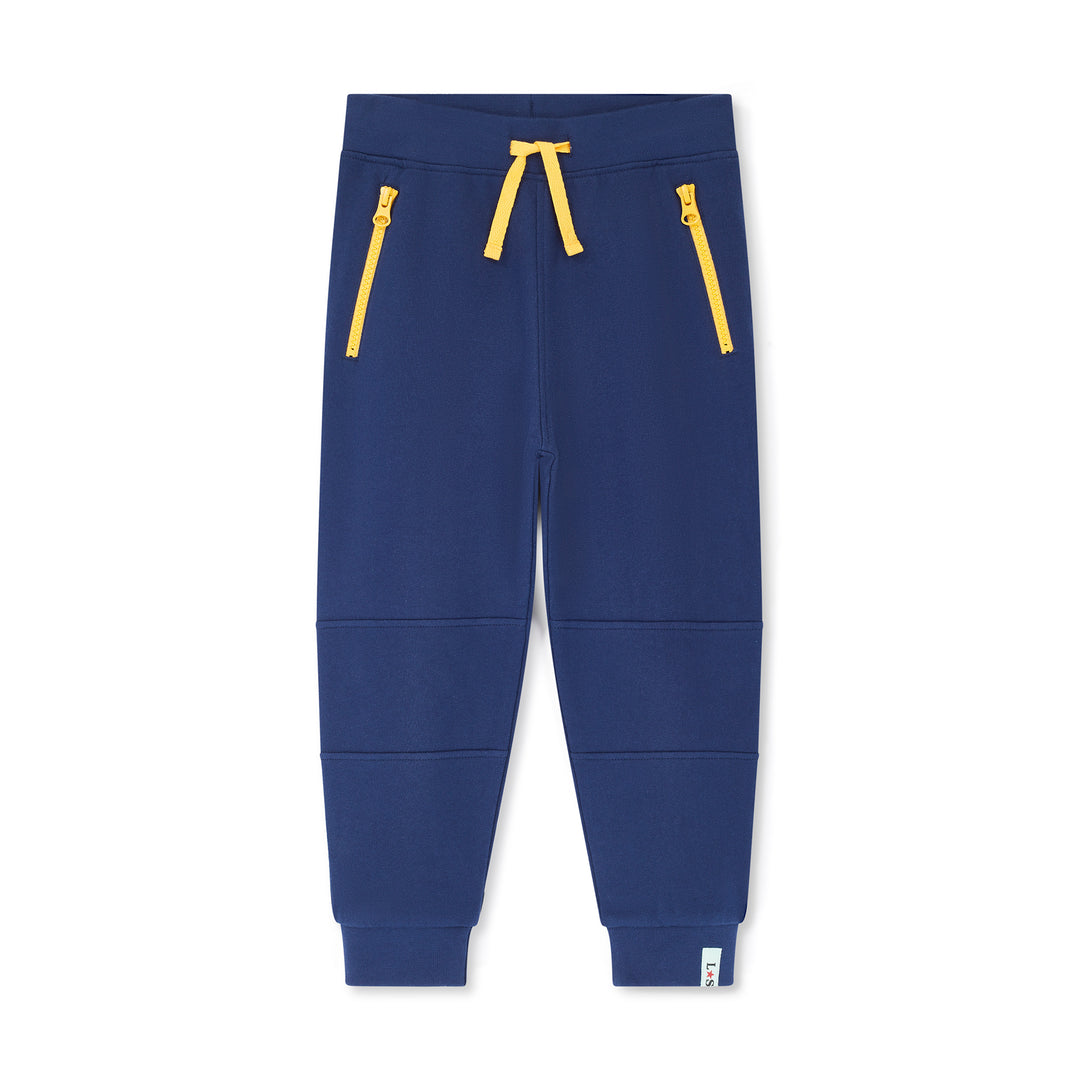 Blue jogger pants with yellow zippers on a white background