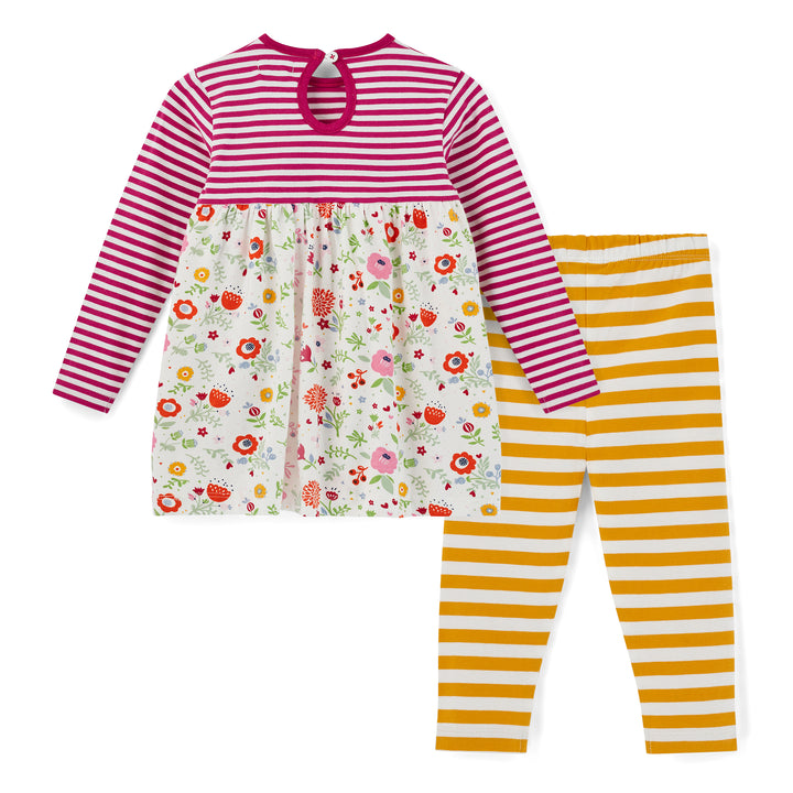 Children's outfit with floral dress and striped pants on a white background