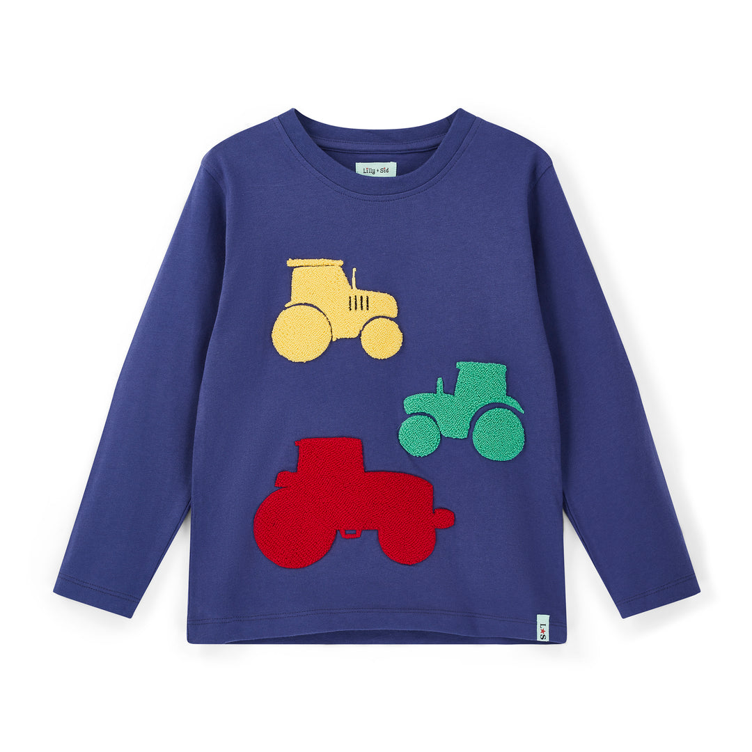 Children's long-sleeve shirt with colorful tractor designs on a white background