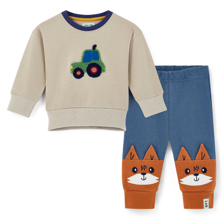 Children's outfit with beige sweater and blue pants featuring a fox design on a white background