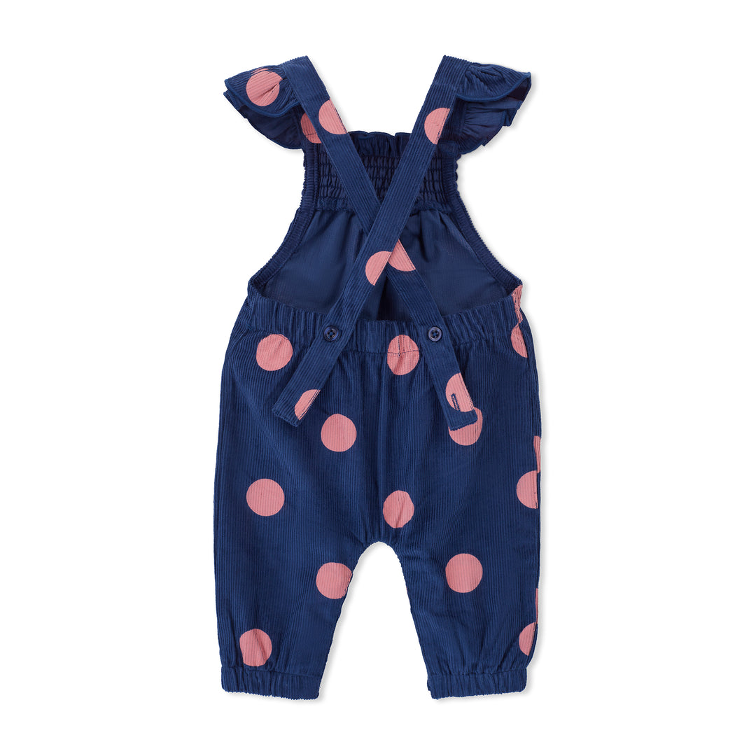 Navy blue romper with pink polka dots on a white background
