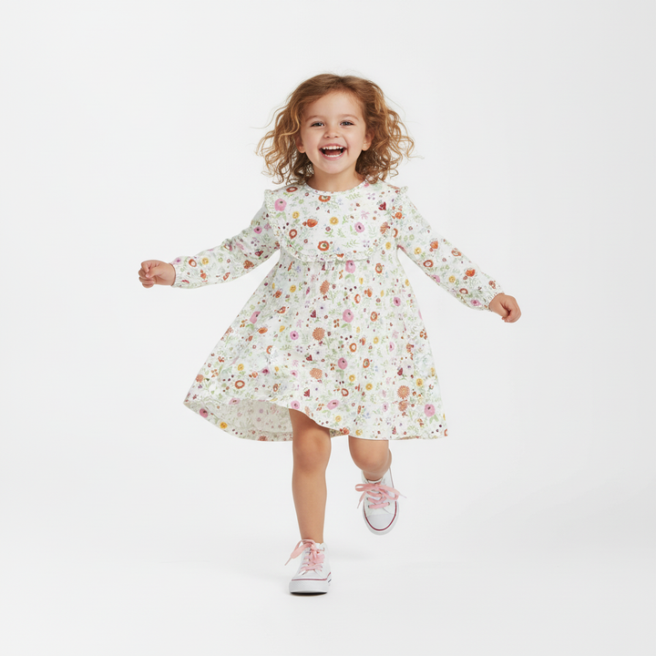 Child wearing a floral dress on a white background