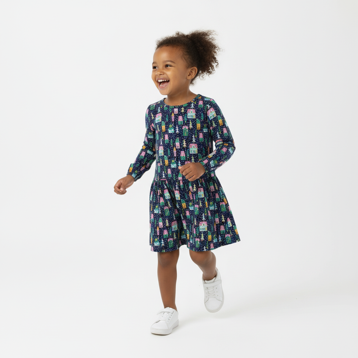 Child wearing a patterned dress on a white background