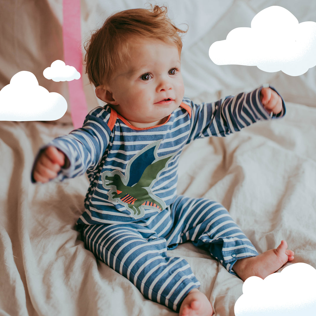 Baby boy wearing sustainable organic cotton baby playsuit