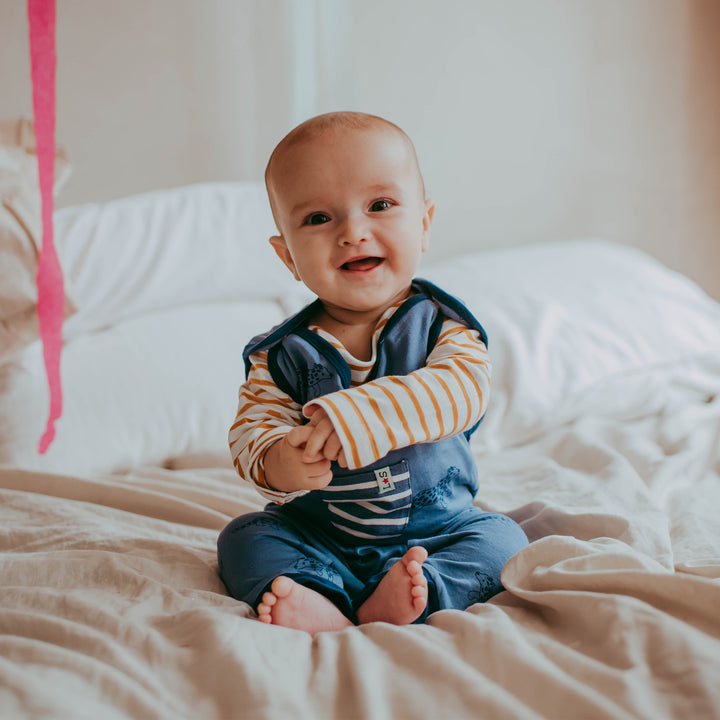 Baby boy wearing organic cotton baby dungarees and baby top set