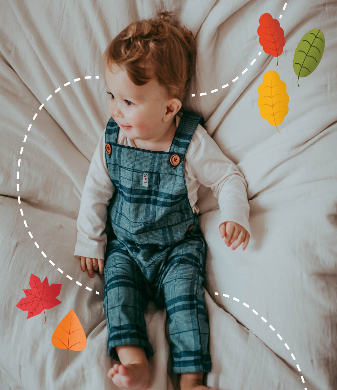 Baby boy wearing sustainable organic cotton woven baby dungarees