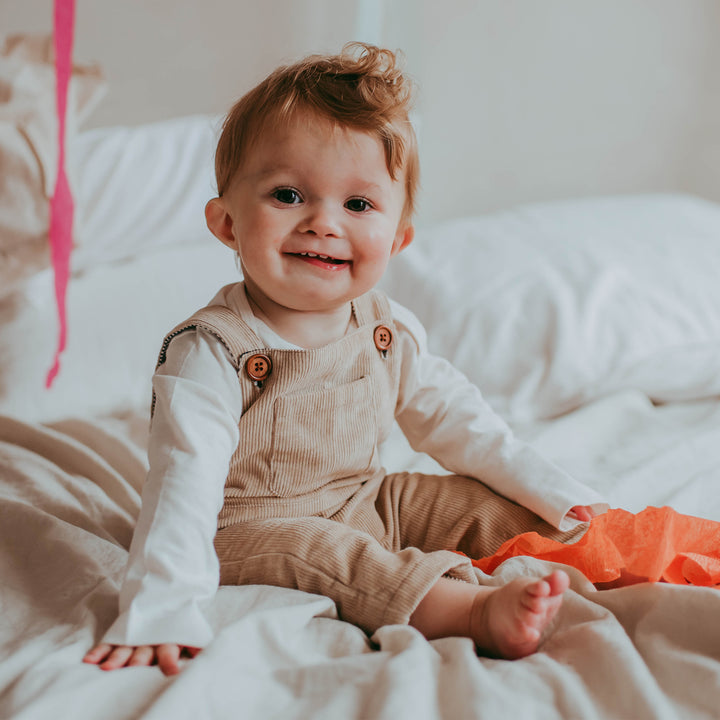 Baby boy wearing organic cord baby dungarees