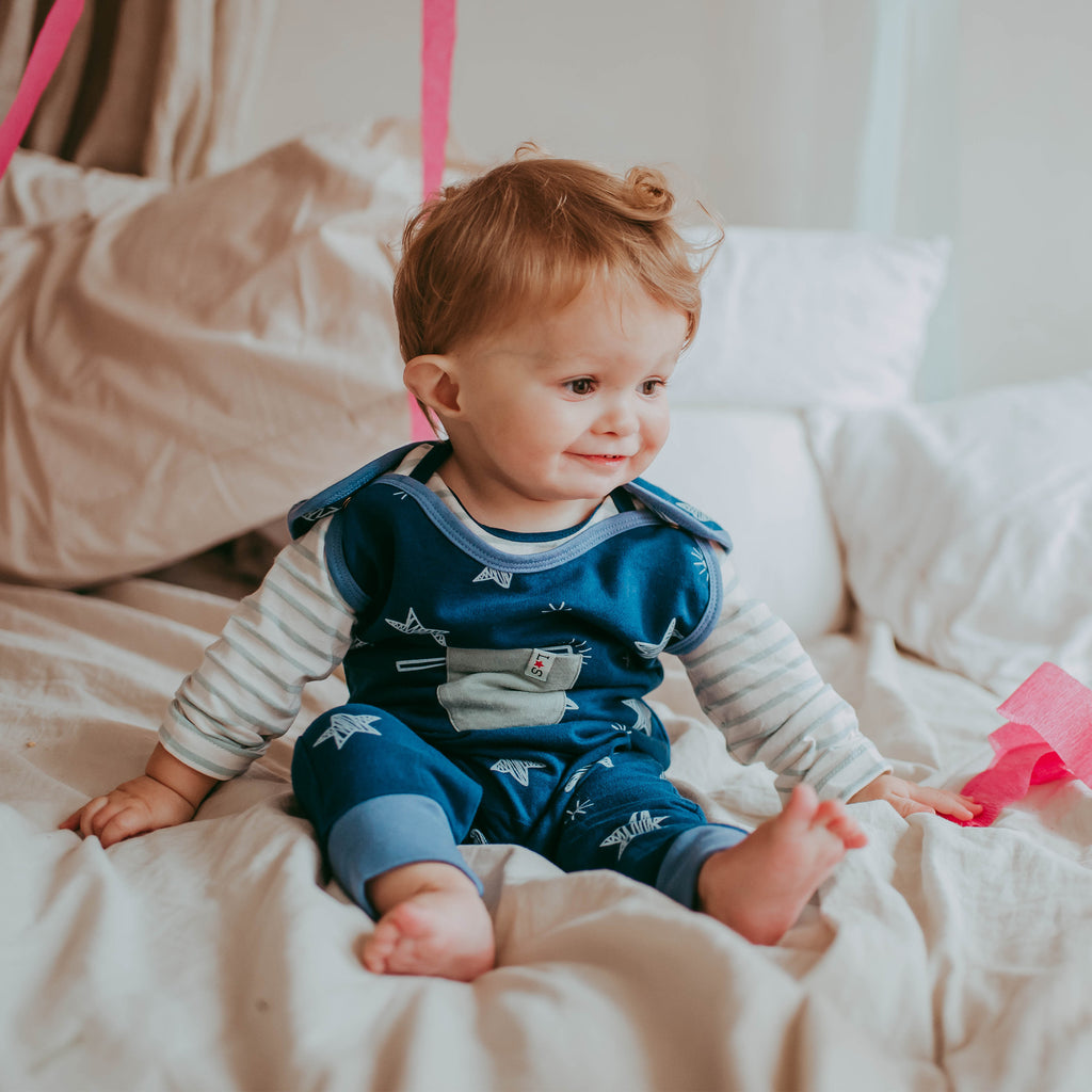 Baby boys wearing sustainable organic cotton baby dungarees and top set