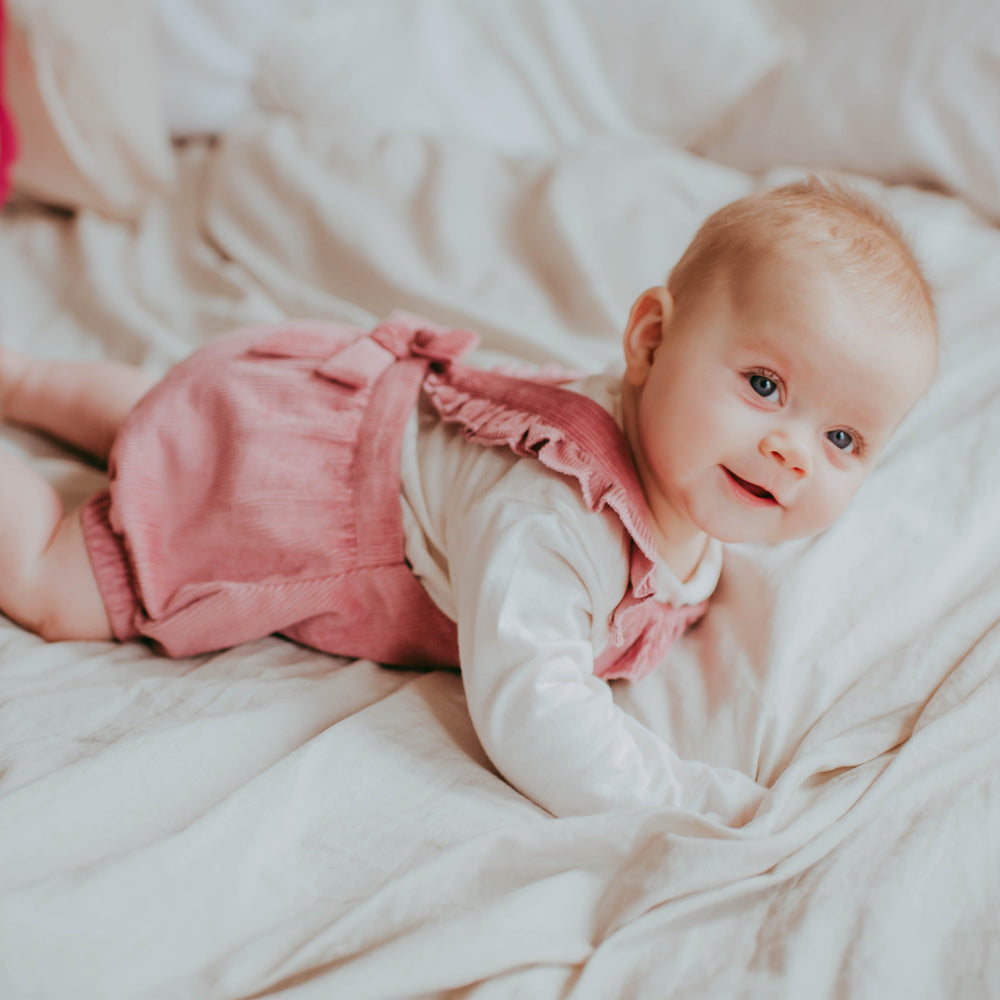 Baby girl wearing organic cotton cord baby romper