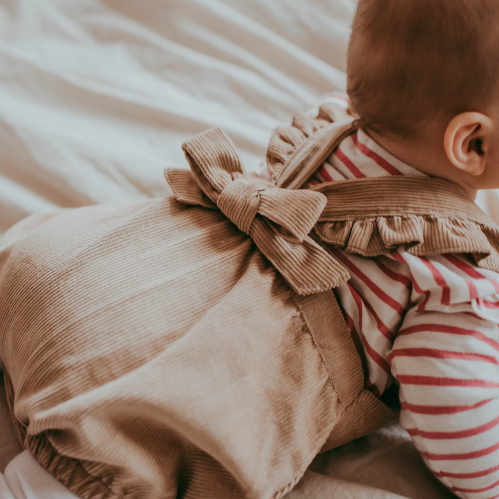 Baby girl wearing organic cotton cord baby romper