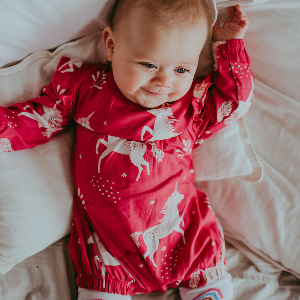Baby girl wearing organic cotton baby romper