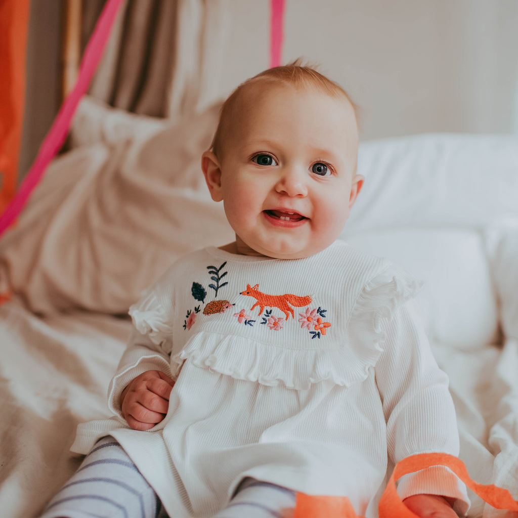 Baby girl wearing organic cotton rib tunic top and stripe leggings baby sett