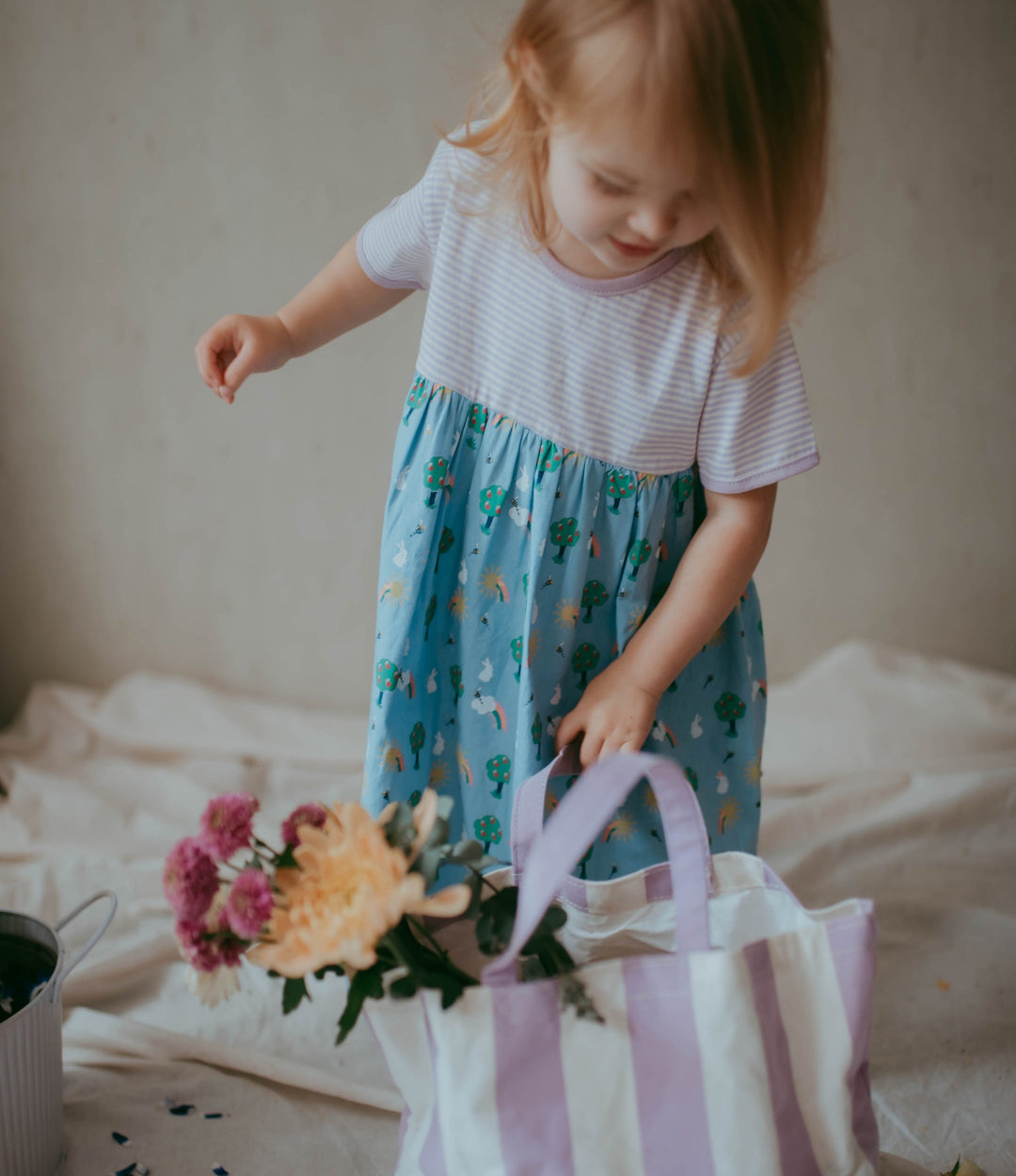 Toddler wearing purple stripe and bunny dress