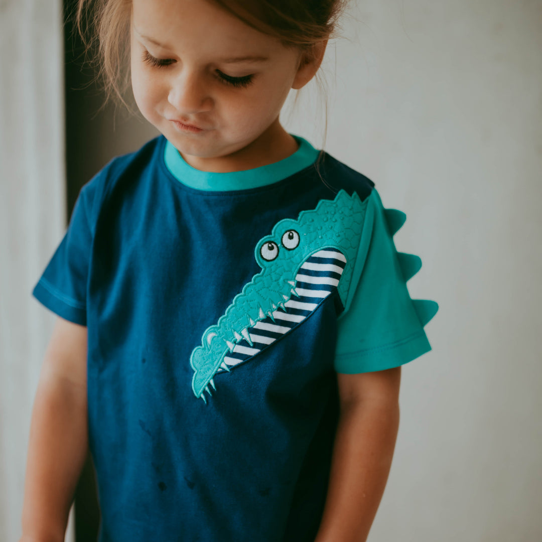 Boy wearing organic cotton navy crocodile kids t-shirt